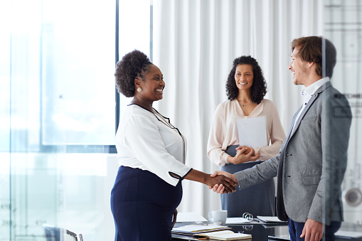 recruiters shaking a black applicant